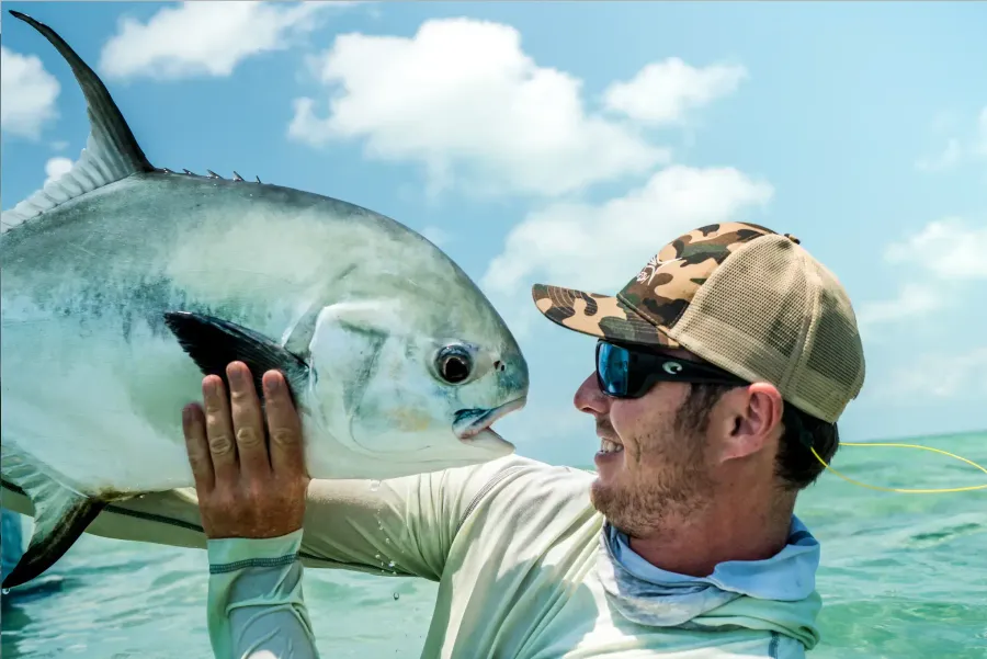 Marcus Webb guiding a client on a fishing charter out of West End Roatan Honduras pointing out fish on the water