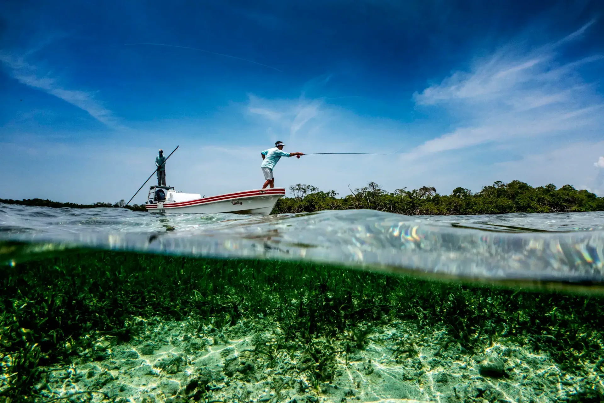 Roatan northwest flats at low tide, clear shallow turquoise water over white sand and turtle grass