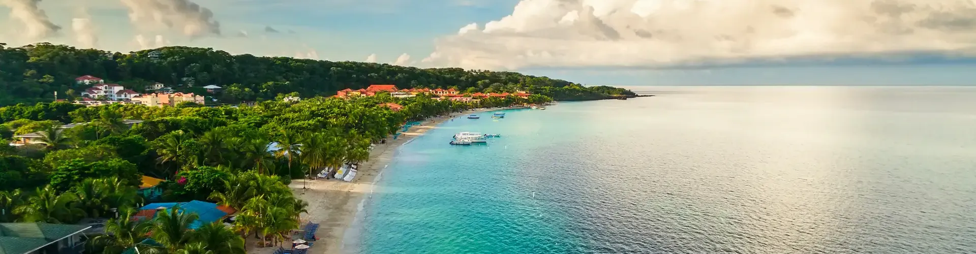 Charter fishing boat moored at West End dock in Roatan Honduras at dawn before departure